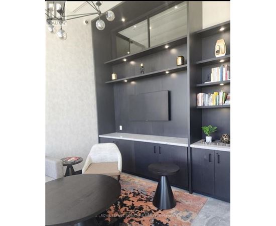 A modern living room with a grey sofa and a black coffee table.