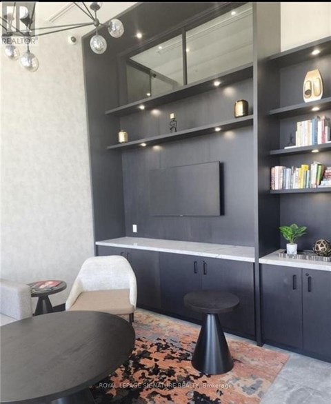 A modern living room with a grey sofa and a black coffee table.
