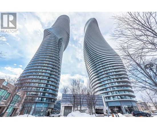 Two tall buildings with curved glass facades stand side by side.