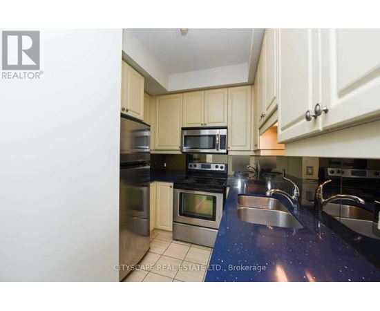 A kitchen with a blue counter top and stainless steel appliances.