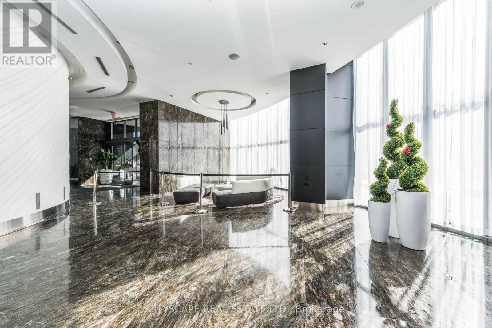 A modern living room with a marble floor and a large window.