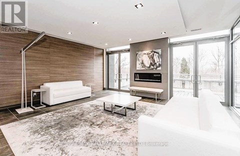 A modern living room with a white sofa and a coffee table.