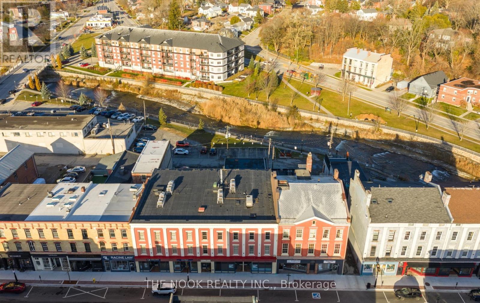 A street view of a town with buildings and cars.