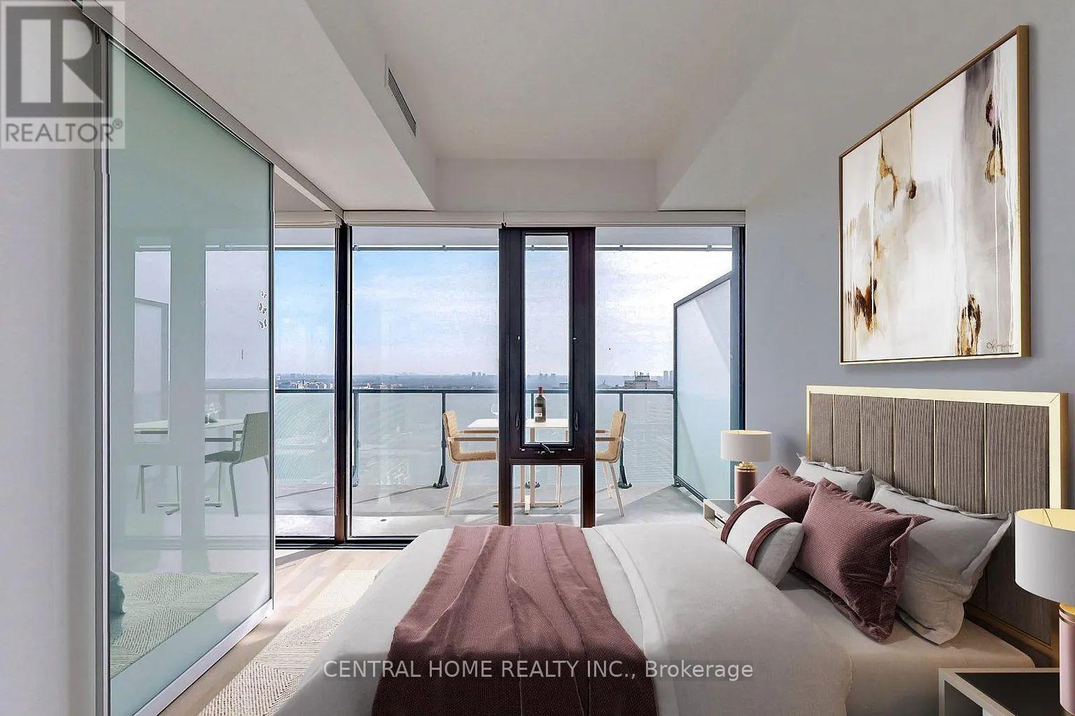 A bedroom with a large bed and a view of the water.