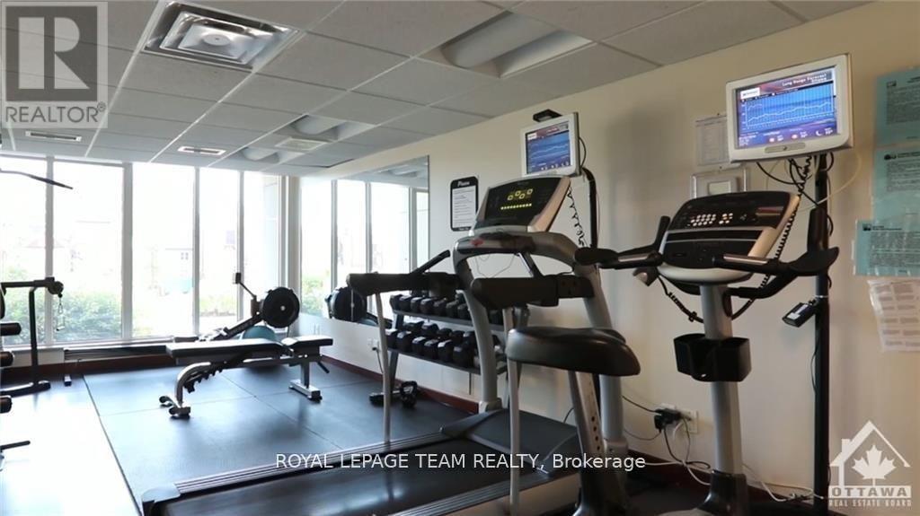 A gym room with a treadmill, weights, and exercise equipment.