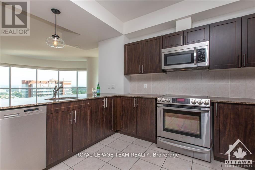 A kitchen with a stainless steel oven and microwave above it.