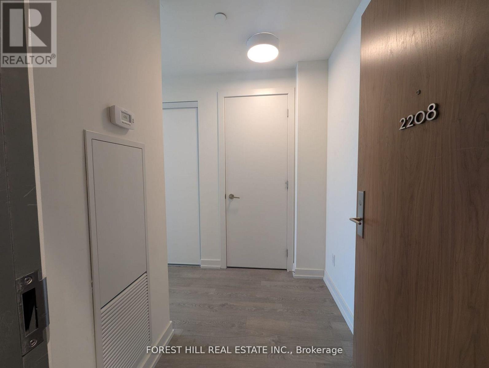 A hallway with a door numbered 2208 on the right.
