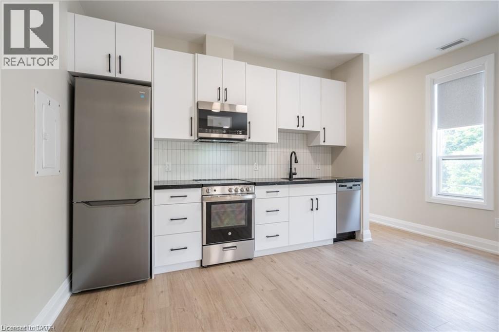 A kitchen with white cabinets and stainless steel appliances.