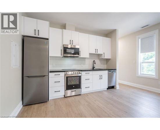 A kitchen with white cabinets and stainless steel appliances.