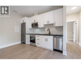 A kitchen with white cabinets and stainless steel appliances.