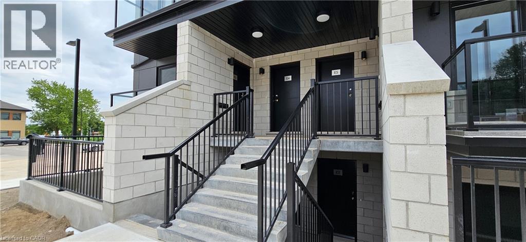 A building with a black railing and a glass window.