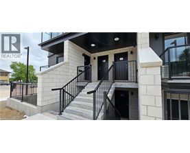 A building with a black railing and a glass window.