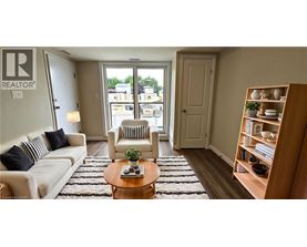 A living room with a white couch, a wooden coffee table, and a bookshelf.