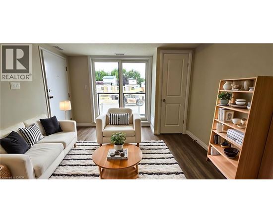 A living room with a white couch, a wooden coffee table, and a bookshelf.