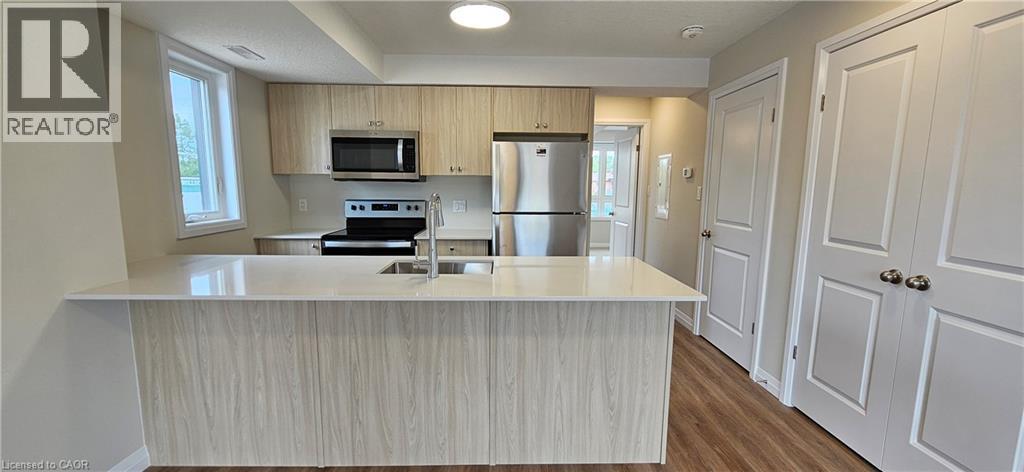 A kitchen with a white counter top and wooden cabinets.