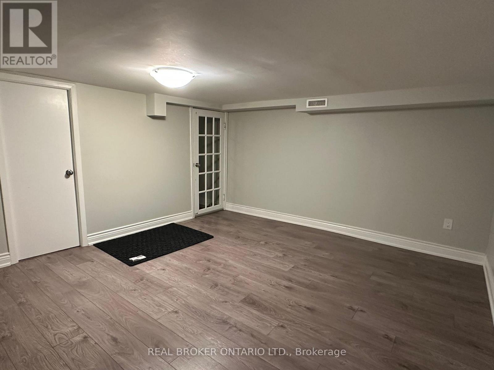A room with a door and a window with blinds.