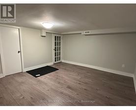 A room with a door and a window with blinds.