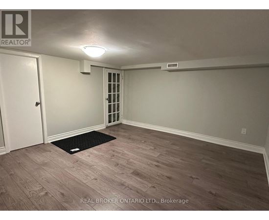 A room with a door and a window with blinds.