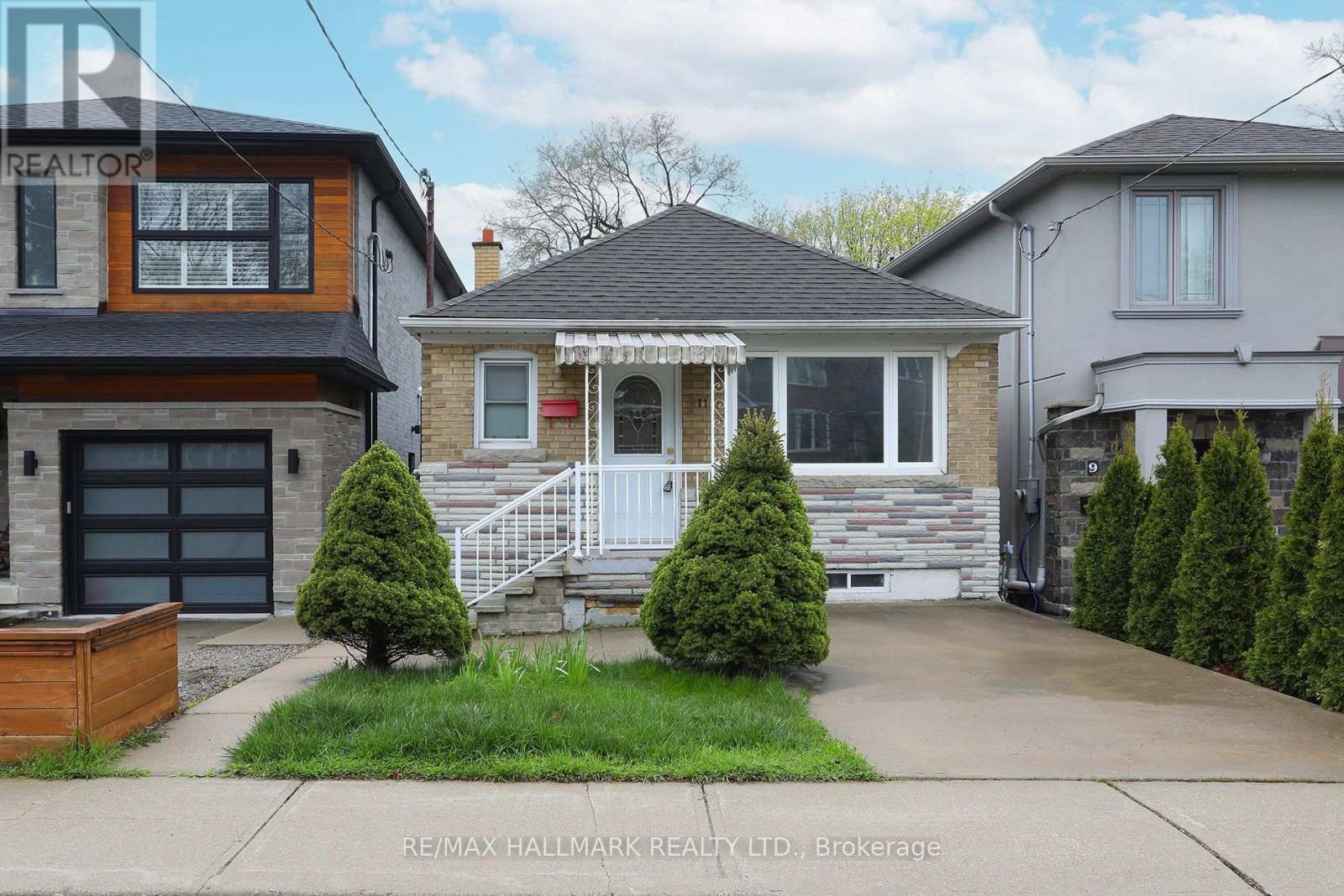 A house with a front yard and a garage is for sale.