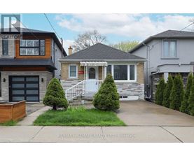 A house with a front yard and a garage is for sale.