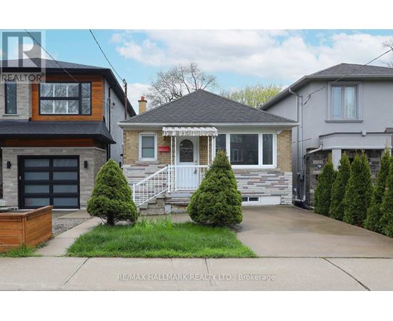 A house with a front yard and a garage is for sale.