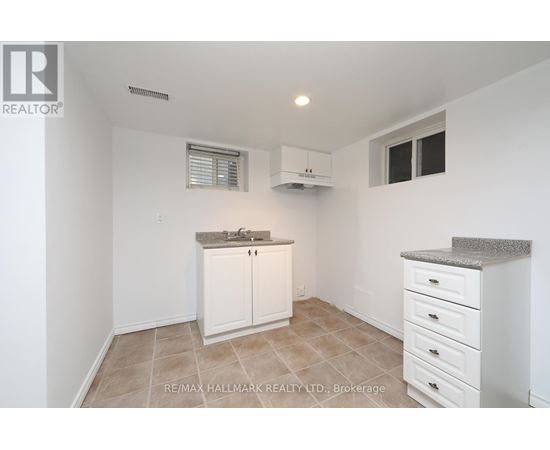 A kitchen with white cabinets and a countertop.