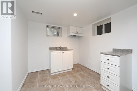 A kitchen with white cabinets and a countertop.
