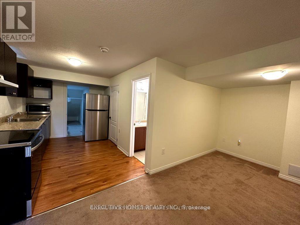 A well-lit, empty room with a doorway leading to another room.