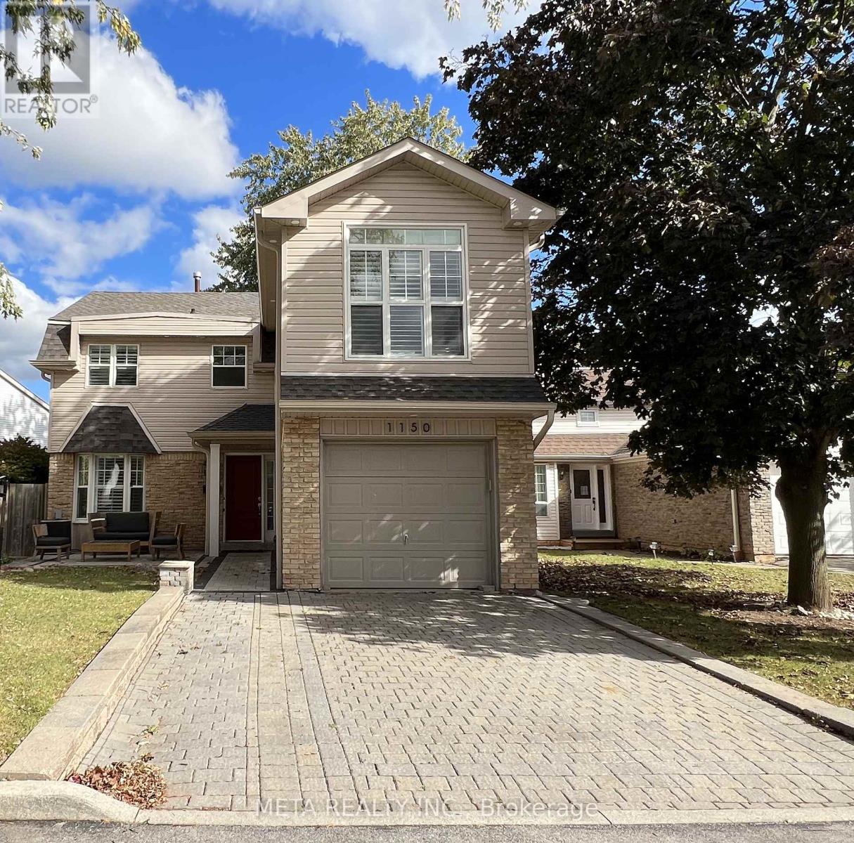 A two-story house with a garage is for sale.