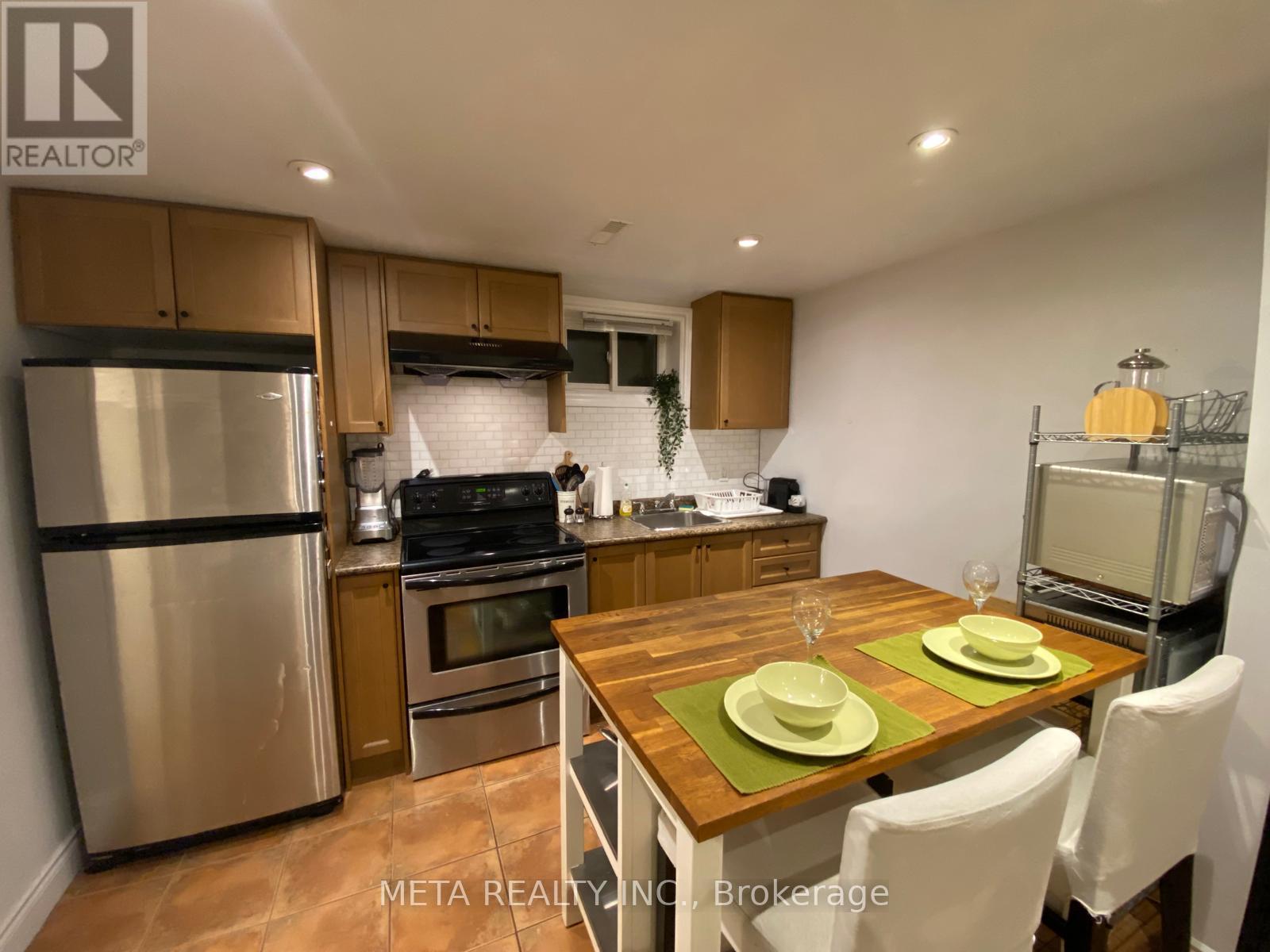 A kitchen with a table set for two.