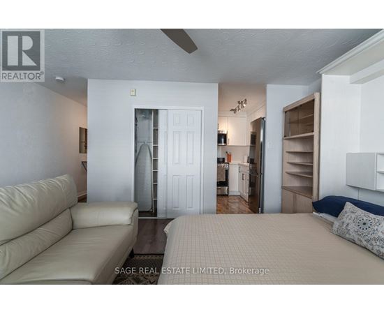 A living room with a couch and a bed.