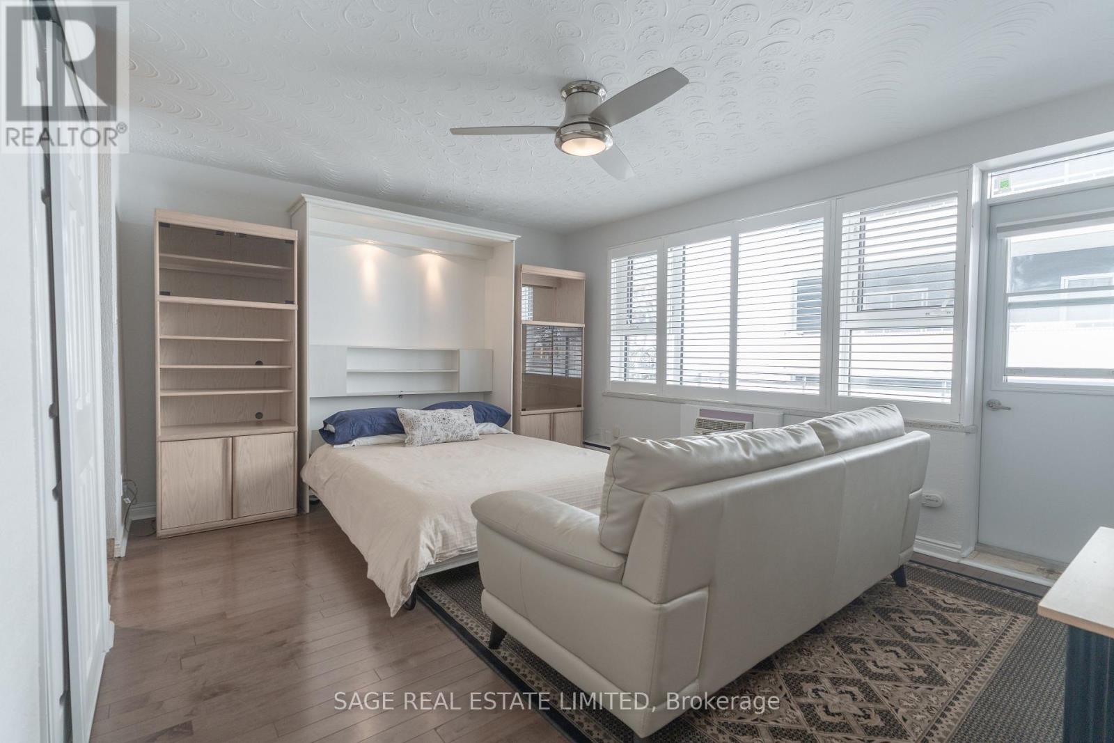 A bedroom with two beds and a couch.