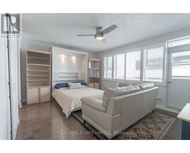 A bedroom with two beds and a couch.