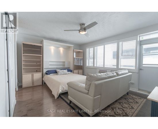 A bedroom with two beds and a couch.