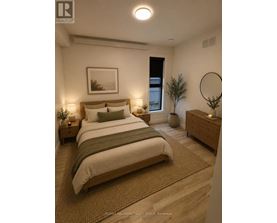 A bedroom with a large bed, a nightstand, and a plant.
