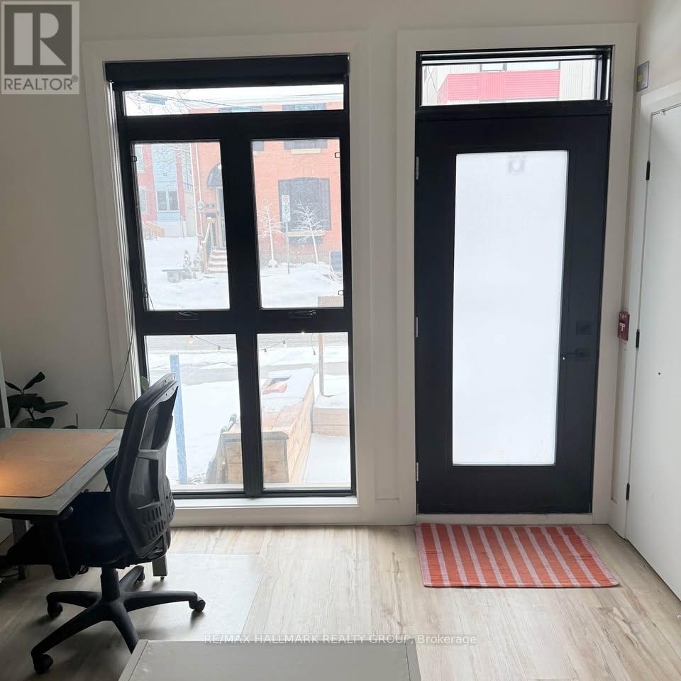 A room with a desk and a chair in front of a window.