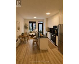 A modern kitchen with a washing machine and a refrigerator.