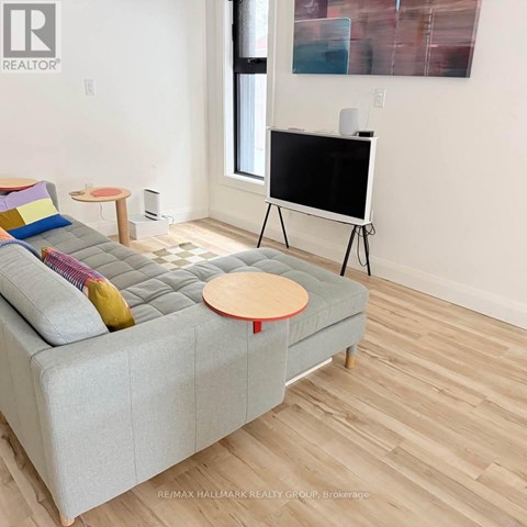 A living room with a grey couch and a flat screen TV.