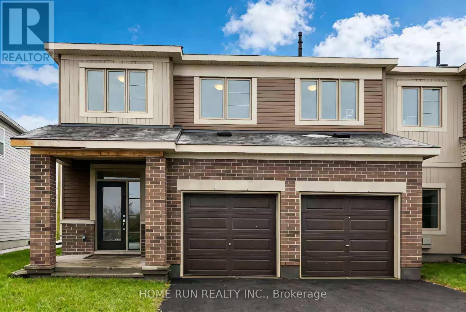 A two-story house with a garage is for sale.