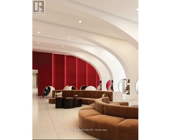 A modern living room with a curved wall and a person sitting on a chair.