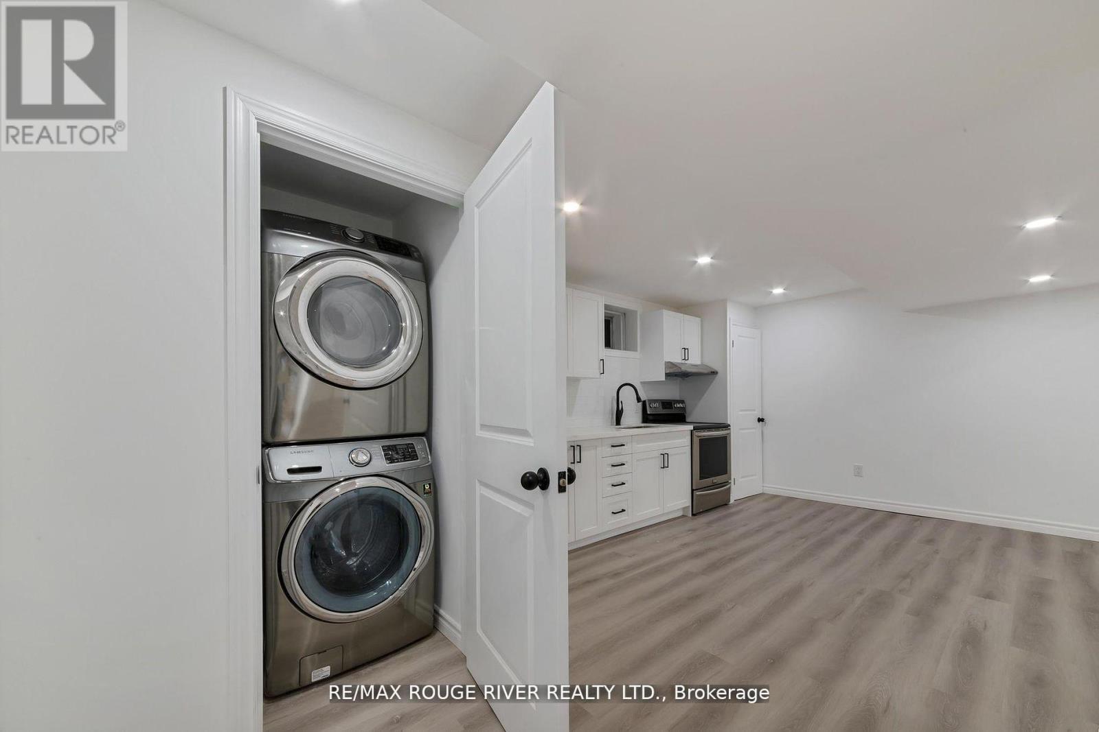 A laundry room with a washer and dryer in a cabinet.