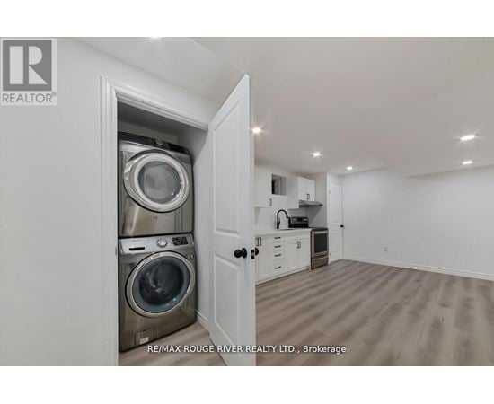 A laundry room with a washer and dryer in a cabinet.