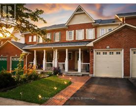 A brick house with a green door and a white garage door.