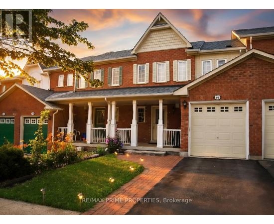 A brick house with a green door and a white garage door.