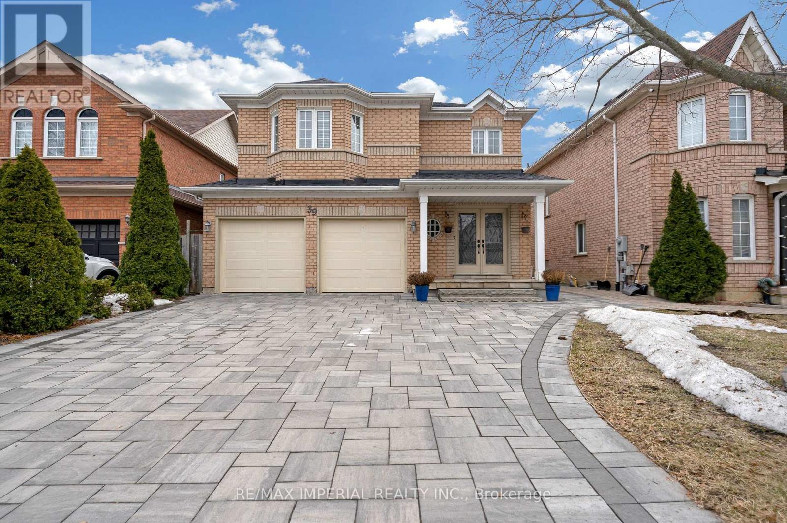 A large house with a driveway in front of it.
