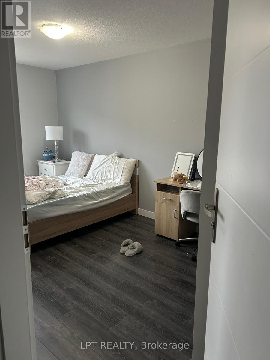 A bedroom with a bed, desk, and chair.