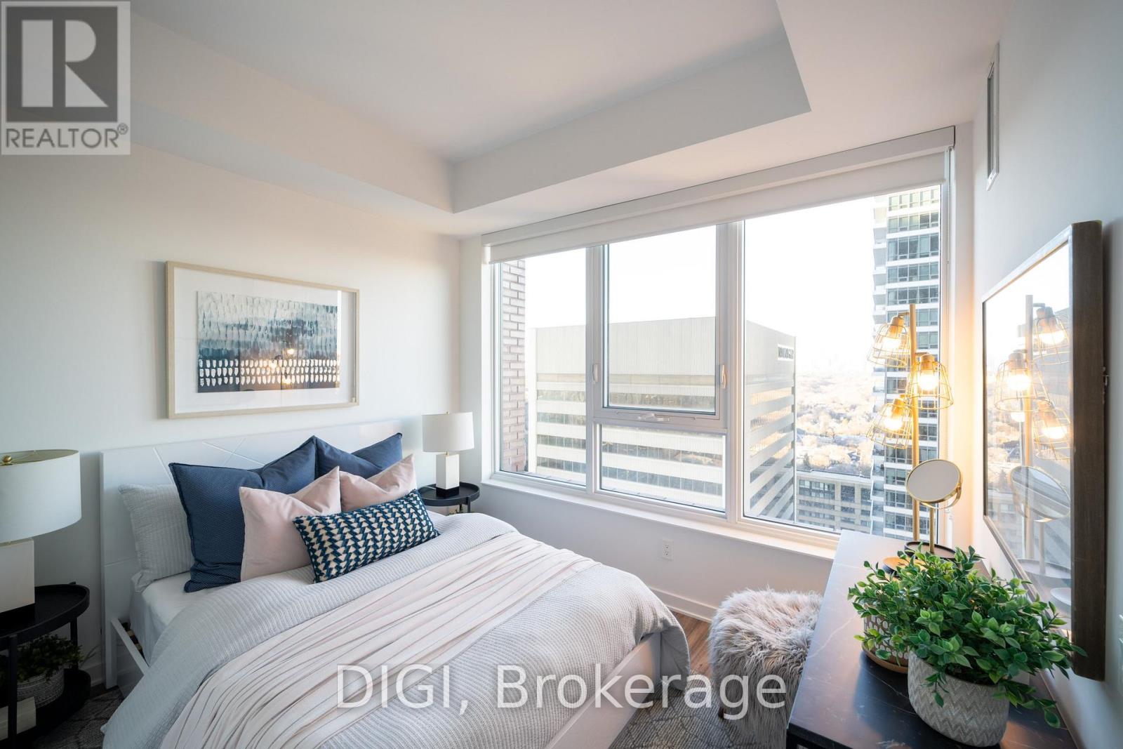 A bedroom with a large bed and a view of the city.
