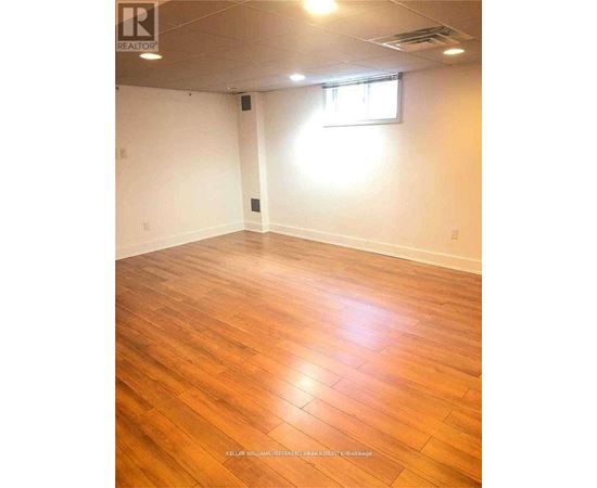 A room with wooden flooring and a window.