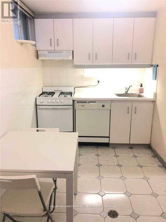 A small kitchen with a table and chairs.