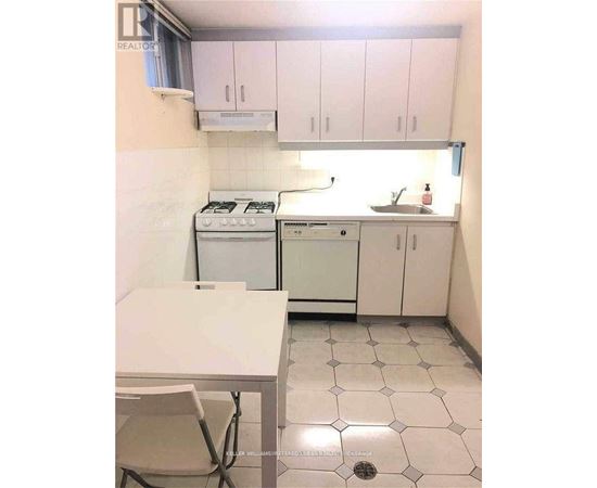 A small kitchen with a table and chairs.